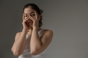 Young woman covering face with hands expressing anxiety and stress