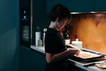 Young Chef Crafts Stylish Homemade Pizza