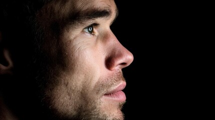 Obraz premium Dramatic Male Portrait Profile View on Black Background