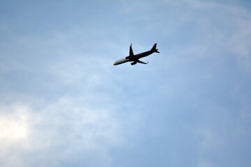 Airplane flying in the blue sky on a sunny day. Airplane flying in the blue sky with white clouds in the background