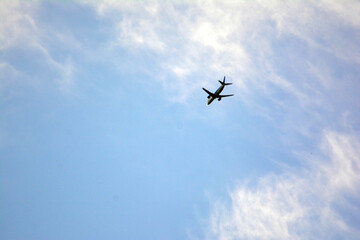 Airplane flying in the blue sky on a sunny day. Airplane flying in the blue sky with white clouds in the background