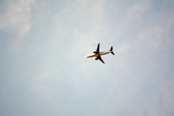 Airplane flying in the blue sky on a sunny day. Airplane flying in the blue sky with white clouds in the background