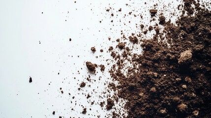 Earthy brown soil scattered on a white surface