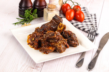 Prepared tasty beef ribs with sauce