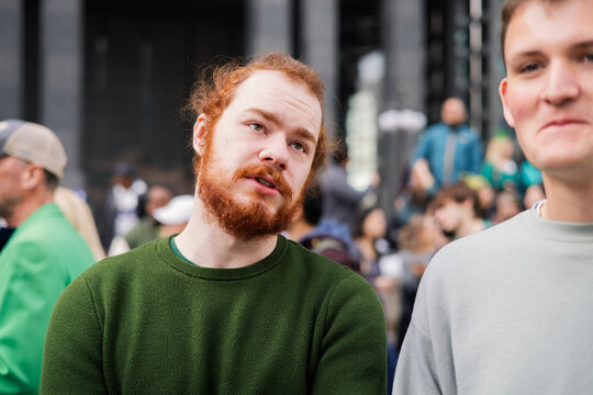 Two friends looking around during St Patrick's Day in Chicago