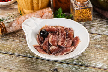 Canned anchovy with oil in the bowl