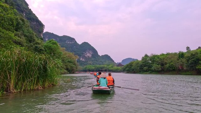 Trang An River Ninh Binh and Bai Dinh Mountain ranges in Vietnam only 3 hours drive from Hanoi. Beautiful winding river and large rising mountains. boats going through the caves in the river