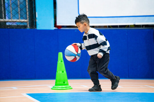 Chinese Boy in Basketball Class