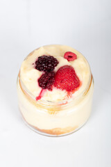 Delicious creamy dessert in glass jars topped with fresh strawberries, blackberries, and raspberries, perfect for sweet moments, homemade treats, and dessert lovers