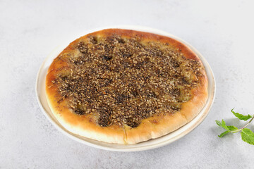 Traditional Middle Eastern flatbread zaatar manakish with olive oil and mix of zaatar spices - thyme, sesame, sumac