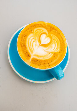 cup of cappuccino with a decorative heart on top