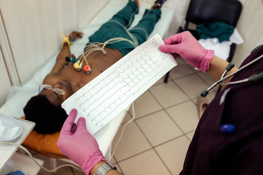 A cardiologist reads a patient's cardiogram at hospital.