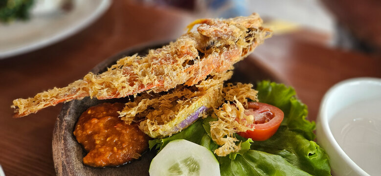 Authentic Indonesian Goreng kipas , deep fried fish with spicy chilli paste.