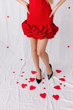Red dress with ruffles and high heels on scattered hearts