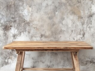 Rustic wooden table against a textured gray wall for product display and presentation background