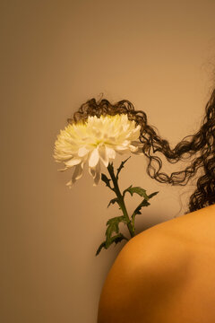 Curly hair tangled in a flower