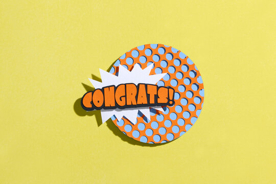 Creative paper cutout with the word 'Congrats!' in comic text