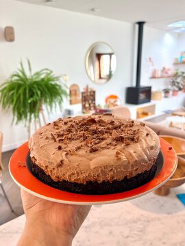 delicious chocolate cake with decoration on an orange plate