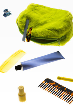 Bright green bag with scattered hair care items
