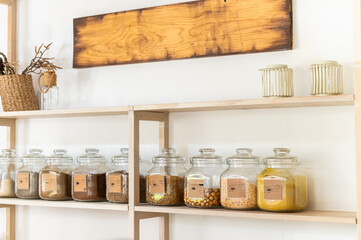 Minimalist kitchen shelf with glass jars and cozy decor