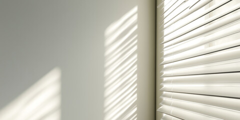 Obraz premium White wall with striped sunlight from horizontal blinds
