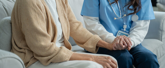 Mental health and elderly care concept.Close up hands of helping hands elderly home care.Arthritis person's hand in support of geriatric doctor or nursing caregiver.Mother and daughter.
