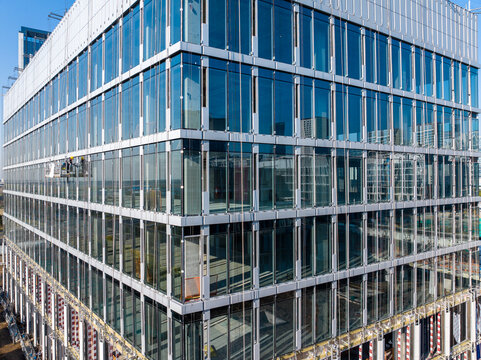 Construction Workers Installing Glass Windows on a Building