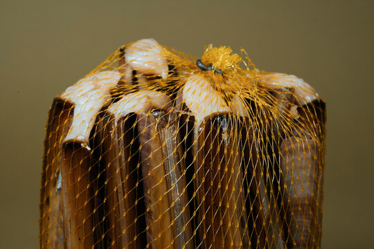 closeup of some clams packed in a mesh bag