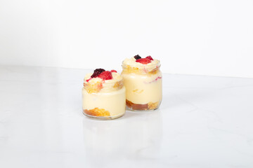 Delicious creamy dessert in glass jars topped with fresh strawberries, blackberries, and raspberries, perfect for sweet moments, homemade treats, and dessert lovers
