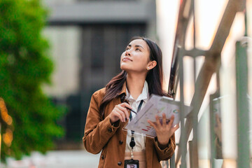 Obraz premium Female Architect Reviewing Plans for Eco-Friendly Building.