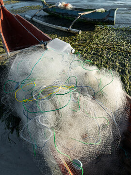 Fishing net with colorful ropes on wooden boat