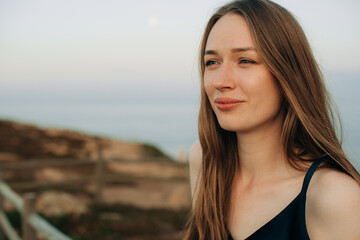Woman looking into distance with serene ocean backdrop