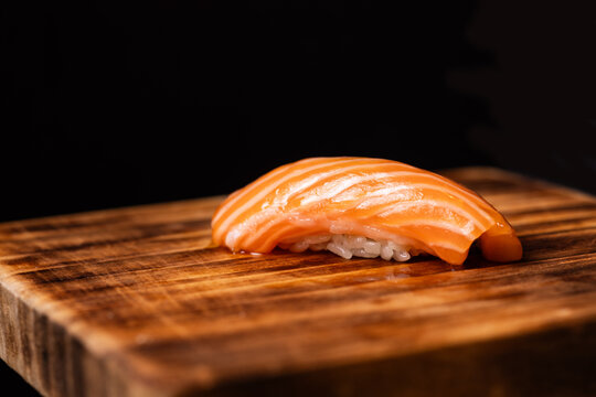 Salmon nigiri sushi on a wooden serving board
