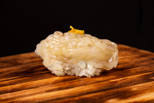 Sushi with fresh squid on wooden board