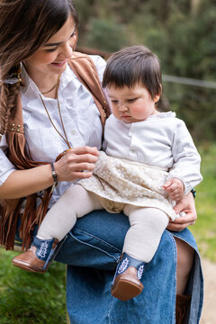 Venezuelan immigrant mother holding her baby daughter
