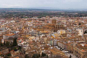 Obraz premium A panoramic view of the City of Granada in Spain on a cloudy morning as seen from the Alhambra Palace.