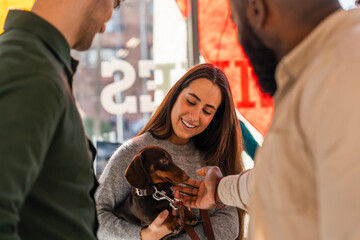Group interacts with a small dog in a pet friendly office setting