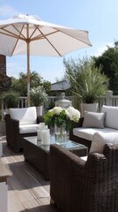 Obraz premium Elegant outdoor patio with white furniture and umbrella in garden setting