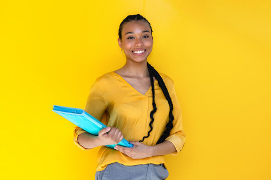 Latin young professional woman holding blue folder