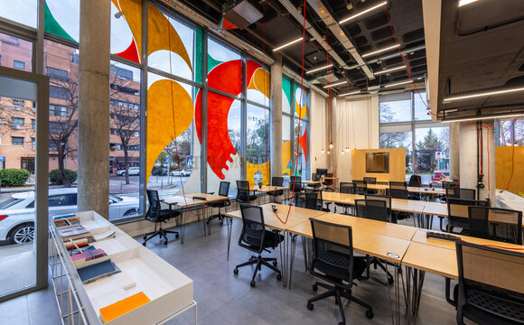 Modern coworking space with vibrant window art
