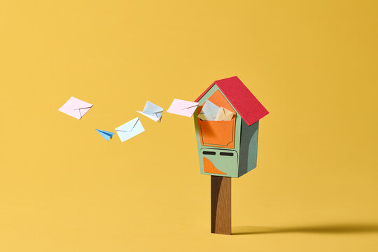 Conceptual paper mailbox overflowing with letters