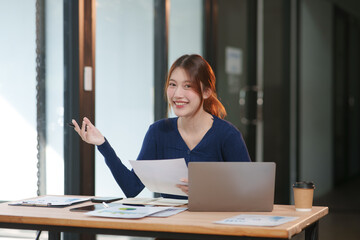 Asian businesswoman working on documents in an office