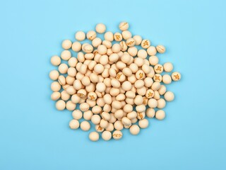 an image of a pile of white beans on a blue surface, there is a pile of white beans on a blue surface
