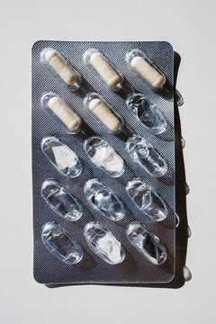 Blister Pack with Partially Used Capsules on White Background
