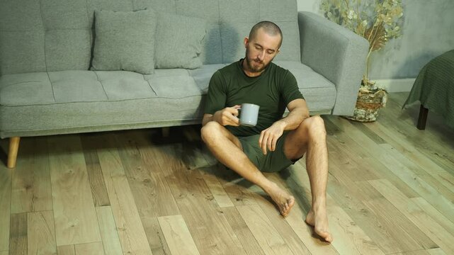 Young attractive man drinking coffee in the morning.