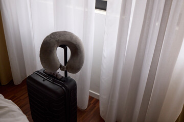 Neck pillow on top of a suitcase