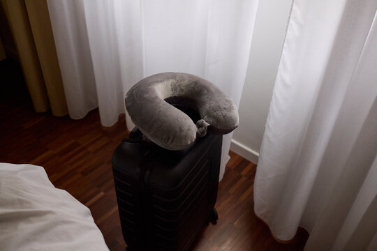 Neck pillow on top of a suitcase