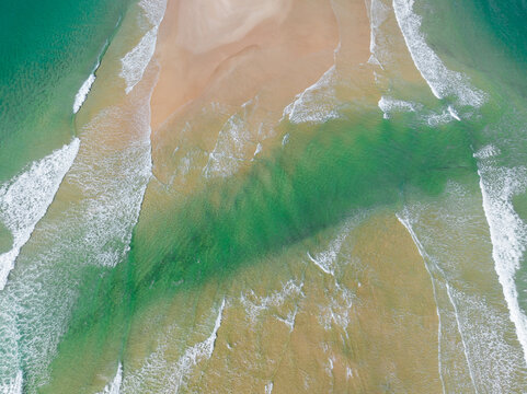 Coastal sand bar cut by waves and sea channel
