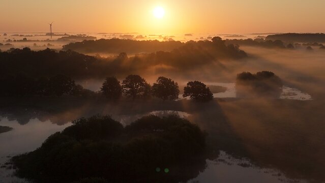 Arial sunrise over fields and medows