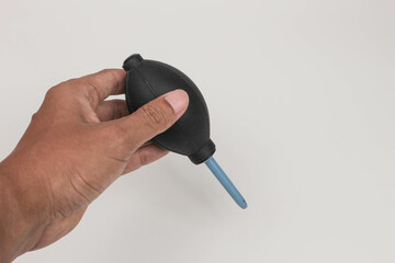 hand holding air blower camera cleanser
